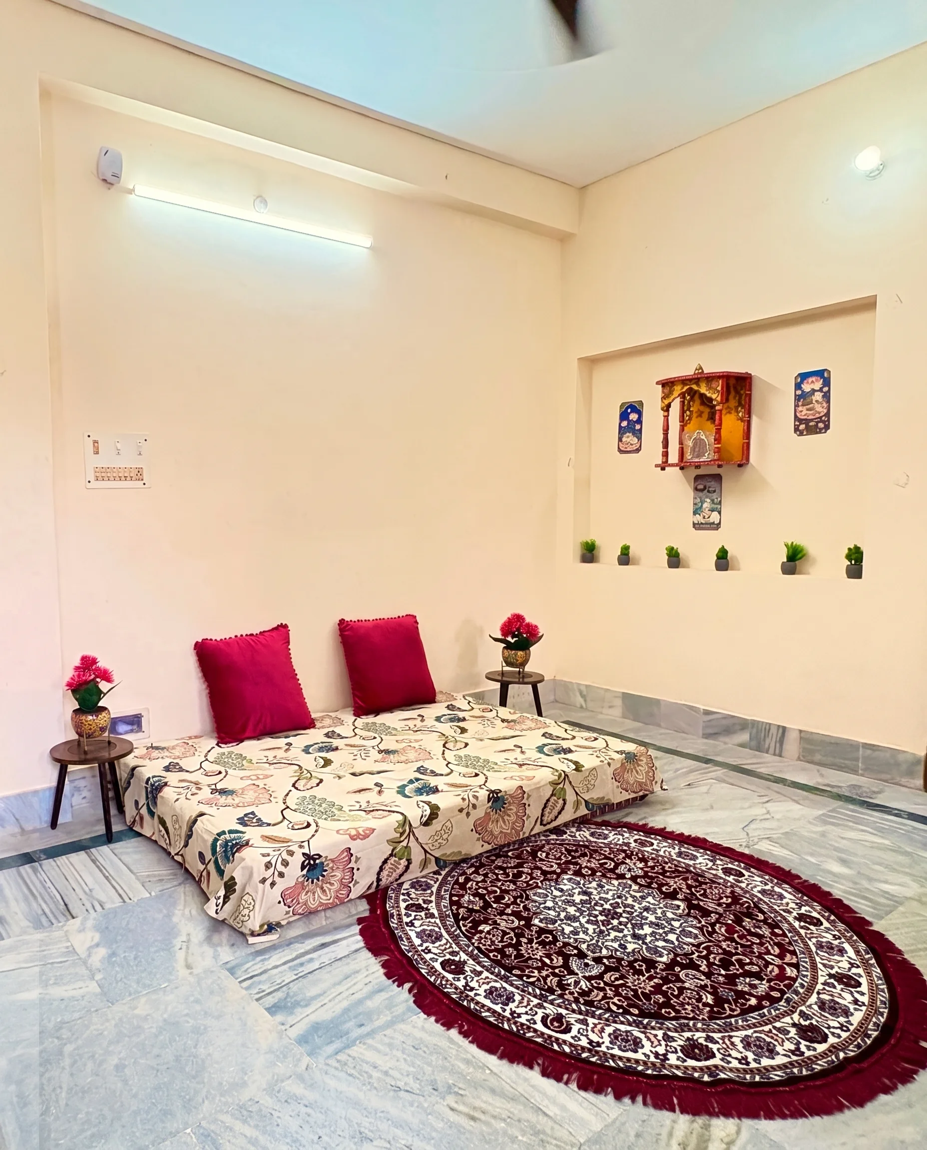 Living room with floor seating and prayer nook